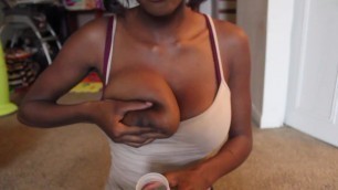 Ebony woman pumps milk from her big areola